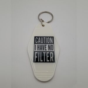 White Motel Keychain with Caution Message
